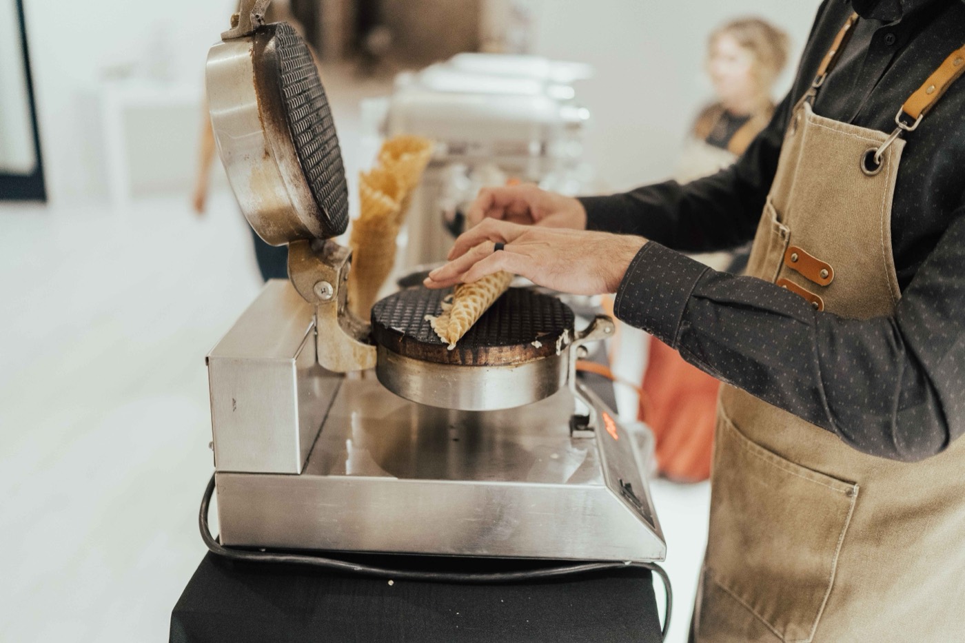 Pressing a fresh waffle cone at a Polar Bros event