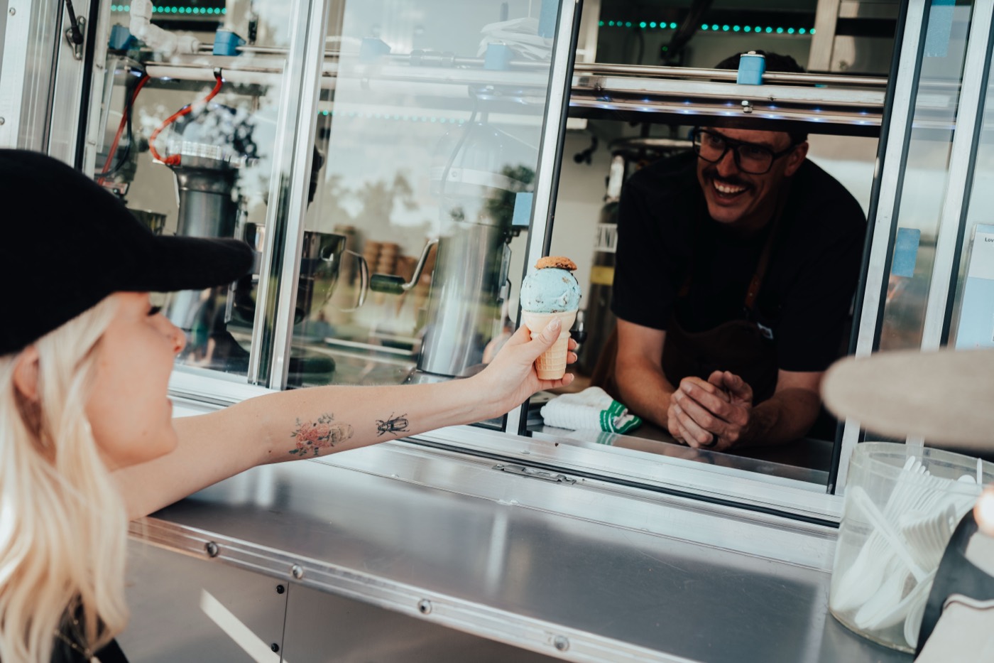 Chef Chuck handing a fresh cone to a guest through the truck window