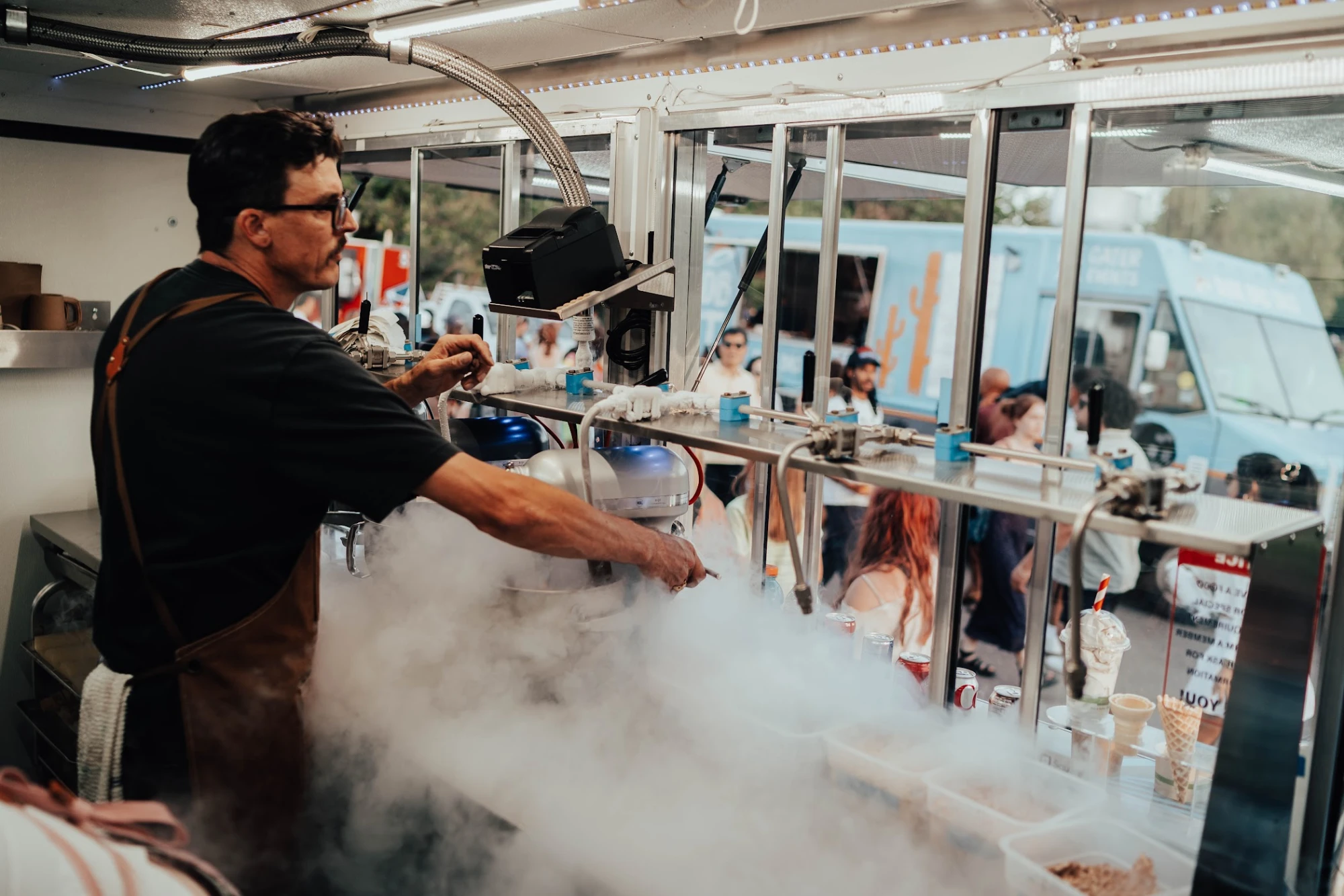 Chef Chuck James freezing a batch of nitro ice cream in a cloud of fog inside the Polar Bros truck